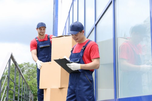 Removal team handling packed boxes during a domestic move