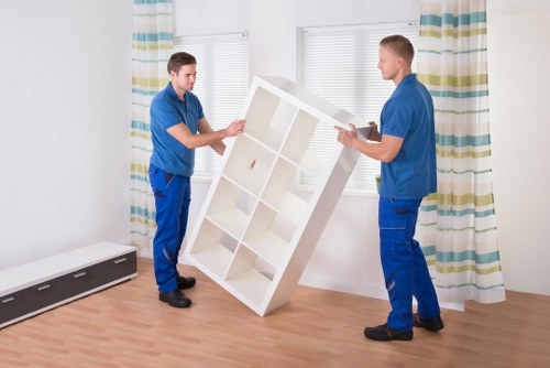 Boxes, wrapped furniture, and essentials arranged for a Finchley house move